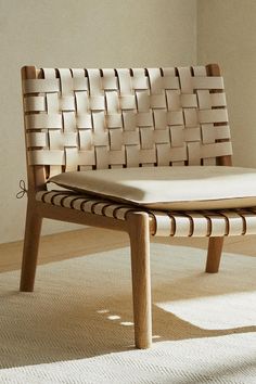 a white chair sitting on top of a carpeted floor next to a wooden frame