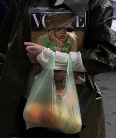 a woman holding a plastic bag with an instagram message on the front and bottom