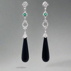 These sophisticated emerald and onyx earrings feature elegant gemstones that exude timeless charm. The deep green of the emerald pairs beautifully with the dark black of the onyx, creating a stunning contrast. Elevate any outfit with these exquisite earrings, perfect for any occasion. 14 Kt White Gold Length : 2.40 inches Onyx Quantity : 2 Emerald Weight : 0.25 ctw Quantity : 2 Diamond Weight : 0.60 ctw Quantity : 92 Style : Dangle/Drop Elegant Onyx Earrings With Polished Finish, Elegant Green Polished Earrings, Elegant Green Earrings With Polished Finish, Classic Emerald Earrings For Formal Occasions, Classic Formal Emerald Earrings, Formal Onyx Gemstone Earrings, Elegant Emerald Gemstone Earrings, Elegant Emerald Earrings With Gemstone Accents, Elegant Emerald Earrings With Gemstones