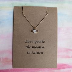 Beautiful handmade saturn necklace Wonderful gift and it comes beautifully presented on an a6 kraft card in a kraft envelope Gold Plated stainless steel Moon And Saturn Necklace, Necklace Planet, Taylor Necklace, Saturn Pendant, Saturn Necklace, Planet Necklace, Necklace Love, Merch Store, Moon Necklace