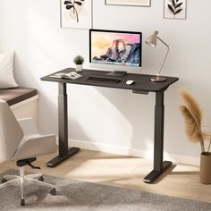 a computer desk with a monitor, keyboard and mouse on it in a living room