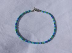 Look cute and summery with this seed bead bracelet/anklet! Perfect for you or as a gift! :)  MATERIALS - 2mm seed beads, elastic cord, silver coloured spring ring clasp LENGTH - Available in 4.5in, 5in, 5.5in, 6in, 6.5in, 7in, 7.5in, 8in, 8.5in and 9in! Please keep in mind every bracelet/anklet is handmade and unique so the size may vary slightly :) ADJUSTABILITY - Bracelet/anklet comes in 1 size only but I can add a chain extension to make it adjustable if needed! Simply message me to request t Dainty Blue Friendship Bracelets With Colorful Beads, Minimalist Blue Friendship Bracelets With Colorful Beads, Dainty Blue Friendship Bracelets With Tiny Beads, Dainty Blue Friendship Bracelet With Tiny Beads, Blue Beaded Minimalist Friendship Bracelets, Blue Minimalist Bracelets With Tiny Beads, Minimalist Blue Bracelets With Tiny Beads, Minimalist Blue Bracelet With Tiny Beads, Dainty Blue Beaded Bracelets For The Beach