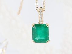 ♥ Solid 14K gold pendant set with a stunning emerald in the center, finished with a diamond-accented bail that can be opened and clipped onto a chain  ♥ The pendant measures 7.2mm in width, 8.3mm in length, and is 4.6mm thick. The bail is 6mm long and will fit with a chain up to 2.2mm thick.    ♥ Material: 14K gold  ♥ Gemstone: Emerald weighs 1.95ct, Diamonds weigh 0.03ct total    ♥ The necklace chain is *NOT INCLUDED*. You can purchase the solid 14K gold chain as an option, or use one of your existing chains for the pendant.     ▶▶ Sign up for our newsletter to receive a 10% off coupon for purchases from our website: https://www.auroradesigner.com/pages/newsletter-sign-up Luxury Emerald Cut Emerald Necklace For Anniversary, Luxury Emerald Cut Gemstone Necklace, Luxury Diamond Cut Emerald Pendant Necklace, Luxury Yellow Gold Emerald Necklace With Prong Setting, Luxury Emerald Cut Emerald Necklace With Diamond Accents, Luxury Emerald Rectangular Pendant Jewelry, Luxury Rectangular Emerald Necklace, Elegant Rectangular Emerald Necklace, Formal Emerald Rectangular Pendant Jewelry