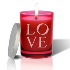 a red candle with the word love on it