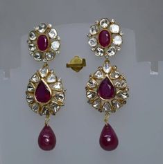 Ruby Gemstone, Uncut Polki Diamond Earring, Wedding Earring, 925 Sterling Silver, Gold Plated, Polki Earring, Ruby Earring, Polki Jewelry. Manufacture Country : India * Customization always available for Ring size, metal selection and any type of center stones changes, etc.... * If you want to make your own idea of Jewelry we can do it. Material : 925 Sterling Silver Main Stone : Ruby Secondary Gemstone : Polki, Pave Diamond Gemstone Color :   Gemstone Shape : As Seen In A Picture Weight : 29.65 gm * Shipment will dispatch within maximum 2-3 Days of Order done * Some Special customization can take more Time * UPS, DHL, FEDEX OR ARAMEX Will be available for Delivery Luxury Hallmarked Ruby Earrings, Luxury Hallmarked Drop Earrings, Diamond Chandelier Earrings In Yellow Gold For Wedding, Yellow Gold Diamond Chandelier Earrings For Wedding, Wedding Chandelier Earrings In Yellow Gold With Diamonds, Wedding Yellow Gold Diamond Chandelier Earrings, Pear-shaped Rose Cut Diamond Earrings For Wedding, Exquisite Ruby Earrings In White Gold, Exquisite White Gold Ruby Earrings