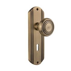 an antique brass door handle with a round knob on the front and side of it