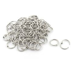 a pile of silver metal rings on a white background