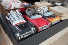 an assortment of toy cars on display in a store's kitchen counter top area