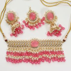 Trendy gorgeous handmade indian jewelry set (necklace, earrings, and tikka) with gold-plated, silver and light pink detailing and white tumble bead work. Fully adjustable necklace Earring length: 3.75 inch  Earring width: 1.45 inch Headpiece/ Tikka length: 6 inch Headpiece/ Tikka width: 2 inch Always gift wrapped & dispatched with free, tracked shipping 🧡 All photos are taken in natural lighting without editing, but our jewelry is really shiny so it may reflect a little differently in different Chandbali Jewelry With Dangling Beads For Diwali, Pink Meenakari Bridal Necklace For Party, Pink Stone Work Necklaces For Party, Pink Stone Work Necklace For Party, Bollywood Chandbali Jewelry With Dangling Beads, Bollywood Style Chandbali Jewelry With Dangling Beads, Adjustable Dangling Beads Jewelry For Weddings, Festive Pink Tikka With Meenakari, Pink Jewelry With Dangling Beads For Celebration