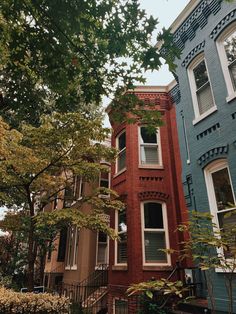 two buildings with trees in front of them