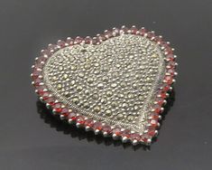 "925 Sterling Silver - Vintage Garnet & Marcasite Love Heart Brooch Pin - BP7493  925 Sterling Silver - Vintage Garnet & Marcasite Love Heart Brooch Pin - BP7493  Jewelry Type:         Brooch Pin   Metal Type:            925 Silver  Metal Size:             1.5\"  Stone Type:            Marcasite & Garnet   Condition:              N/A  Jewelry Weight:     13.4 Grams  PLEASE NOTE: THIS ITEM IS PRE-OWNED. ALTHOUGH MOST ITEMS ARE IN VERY GOOD CONDITION, SOME MAY NEED CLEANING AND/OR MINOR REPAIRS. W Silver Heart Brooch For Valentine's Day, Silver Heart-shaped Brooch For Valentine's Day, Valentine's Day Silver Heart Brooch, Silver Heart Brooches For Gift, Silver Brooches For Anniversary On Valentine's Day, Heart-shaped Brooches For Valentine's Day Anniversary, Heart-shaped Brooch For Valentine's Day Anniversary, Heart-shaped Brooch For Anniversary On Valentine's Day, Vintage Silver Brooches For Valentine's Day