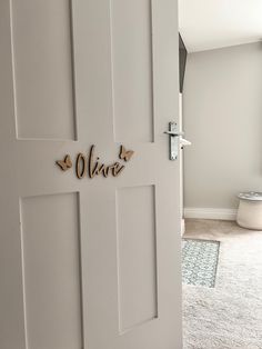 a white door with the name olive on it