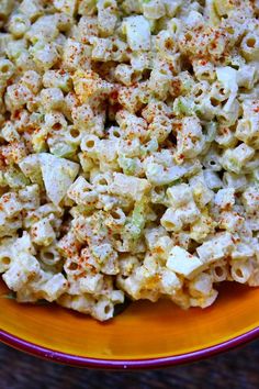 a bowl filled with macaroni salad on top of a table