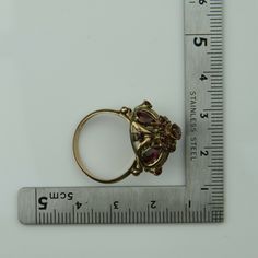 Antique 14K Yellow Gold Ruby Dome Ring, almost rose color gold, .5 inch high, .75 inch across, 4 pear shaped rubies, 12 round rubies, not calibre cut, 3.82 grams, Circa 1940, Size 7. SKU # BB264R25 Most rings are sizable for a small fee. If the ring you are considering is the incorrect size contact us for a quote. This listing contains photographs of the actual item you will receive. Our items are in excellent condition with little or no signs of wear and many are one of a kind pre-owned estate Antique Multi-stone Ruby Ring, Antique 14k Gold Ruby Ring With Multi-stone, Vintage Multi-stone Ruby Cluster Ring, Vintage Ruby Multi-stone Cluster Ring, Vintage Ruby Cluster Ring With Multi-stones, Gold Multi-stone Pear-shaped Ring, Victorian Gold Ruby Ring With Prong Setting, Vintage Multi-stone Ruby Ring, Antique Multi-stone Ruby Ring In Gold