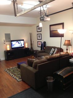 a living room filled with furniture and a flat screen tv mounted to the side of a wall