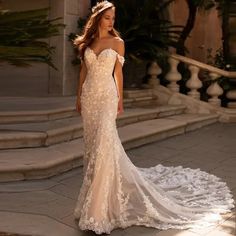 a woman in a wedding dress standing on some steps