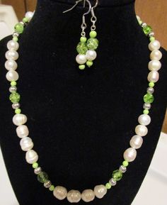 This is a handmade ladies gemstone necklace set. The materials are : cultured (fresh water) pearls, green glass seed beads, green crystals beads and metal. 19" with an ornate, metal toggle clasp Fishhook earrings and bracelet are included. Green Beaded Jewelry Sets With Round Beads, Elegant Lime Green Beaded Jewelry, Handmade Green Pearl Necklaces, Green Pearl Drop Jewelry With Round Beads, Green Pearl Jewelry For May Birthstone, Green Beaded Necklace With Pearl Drop For Gift, Green Beaded Pearl Necklace For Jewelry Making, Green Pearl Round Beads Jewelry, Handmade Green Jewelry Sets With Round Beads