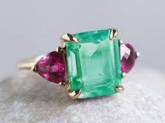 This emerald green quartz solid gold statement ring, is perfect for an especial occasion as an engagement ring or promise ring. It is available in 9k gold and 18k gold. The main stone is an emerald cut green quartz 10x8 mm. The side stones are 2 pink topaz 5mm trilliant cut. You can Choose between yellow and white gold, please see images in variations and choose your favourite. All products are handcrafted and made to order at our workshop in Madrid. Please allow 15-20 business days for manufact Dainty Engagement Ring, Dainty Engagement, Dainty Engagement Rings, Gold Statement Ring, Pink Topaz, Square Rings, Green Quartz, Promise Ring, Jewelry Designs