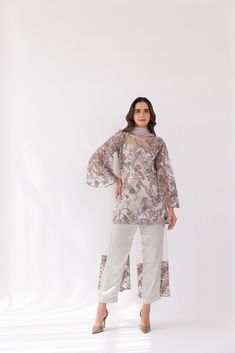 Featuring a silver embroidered boat neck kurta set in net base. It is paired with solid pants and net dupatta with sequin work. Color: SILVER FABRIC: NET Delivery time 15 to 20 days Party Wear Sequined Salwar Kameez For Eid, Party Wear Salwar Kameez With Sequins For Eid, Elegant Designer Salwar Kameez With Sequins, Tissue Silk Long Sleeve Sharara For Party, Long Sleeve Tissue Silk Sharara For Party, Organza Palazzo Set For Eid Party, Eid Party Wear Straight Kurta, Eid Party Organza Palazzo Set, Elegant Sequined Dupatta For Eid