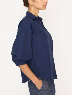 Runs true to size Relaxed fit, take a size down if you prefer a closer fit Collared v-neckline Button front Elbow length sleeves with a blouson (pushed-up) effect Button cuff Scooped, shirttail hem 65% Polyester/35% Cotton Imported Model is 5'9" and is wearing a size Small Inspired by our most-loved Kate Belted Shirtdress, our Kate Shirt has that same easy sensibility that will make you gravitate towards it day in and day out. This perfect shirt can be worn tucked in or loose and relaxed for tho Solid Color Tops With Roll-up Sleeves For Office, Daywear Button-up Shirt With Blouson Sleeves, Spring Button-up Tops With Snap Cuffs, Button-up Tops With Snap Cuffs For Work, Modern Tops With Button Cuffs For Fall, Summer Button-up Tops With Blouson Sleeves, Relaxed Fit Tops With Blouson Sleeves For Work, Relaxed Fit Blouson Sleeve Tops For Work, Relaxed Fit Workwear Tops With Blouson Sleeves