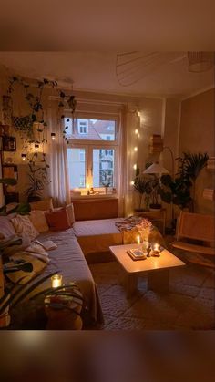 a living room filled with furniture and candles