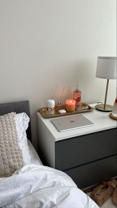 a bed with a tray on top of it next to a night stand