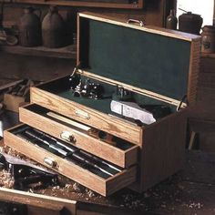 an open wooden box filled with lots of tools