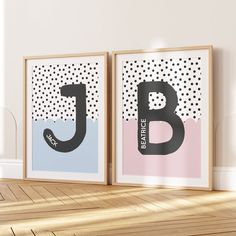 two framed art prints with the letter b and j on them in front of a white wall