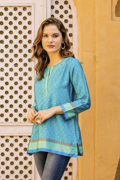 Vivid colors and intricate motifs evoke the beauty of the sea in this satiny Indian tunic. Cotton embroidery along the button placket is a nod to the chikankari embroidery work of artisan Shalabh's hometown of Lucknow. Tunic With Jeans, Indian Tunic, Summer Tunics, Lovely Tops, Embroidered Tunic, Polyester Top, Cotton Voile, Lovely Print, Cotton Blouses