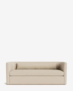 a beige couch against a white wall with no one sitting on the couch in front of it