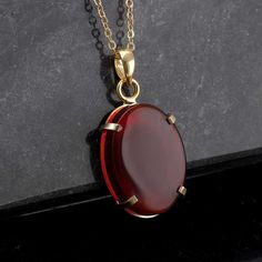 This necklace features an oval-shaped Yemeni agate stone. Yemen aqeeq stones are red and have unique patterns. Each stone is authentic and high quality. The pendant is delicately crafted and set in a 14ct plated case on high-quality sterling silver. The combination of the red agate stone and the eye-catching colour of the gold makes this necklace a true statement piece. This unisex vintage gemstone pendant is a versatile accessory that can be worn by both men and women. Are you looking for a truly unique and special piece of jewelry? Look no further than handmade necklaces! Our Handmade necklaces are crafted by skilled artisans who put their time, passion, and creativity into each piece they make. Unlike mass-produced necklaces, handmade necklaces are one-of-a-kind and have a certain chara Elegant Amber Oval Cabochon Necklace, Amber Cabochon Oval Pendant Necklace, Formal Oval Amber Necklace, Oval Carnelian Yellow Gold Jewelry, Formal Amber Necklace With Oval Pendant, Formal Amber Oval Pendant Necklace, Gold Agate Necklace With Oval Pendant, Gold Agate Oval Pendant Necklace, Oval Amber Necklaces With Natural Stones