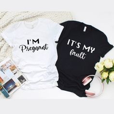 two t - shirts that say i'm pregnant and it's my fault