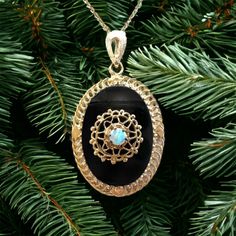 "The bold beauty of this intriguing estate pendant has an artfully set onyx in an oval frame of 14kt yellow gold. The 1\" x 3/4\" oval black onyx cabochon offers a glossy and dramatic backdrop to a pretty 3.5mm round opal cabochon in a decorative setting. It hangs from an open bail on a sterling silver 18\" chain with gold overlay. 14 karat gold chains are available" Gold Sign, Gold Overlay, Oval Frame, Opal Pendants, Fine Jewellery Necklace, October Birth Stone, Black Onyx, Vintage Necklace, Online Jewelry