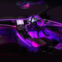 the interior of a car with purple lights