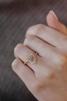 a woman's hand with a diamond ring on it