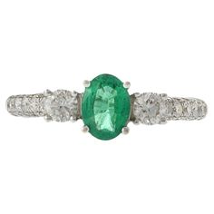 This exquisite ring features a 0.55 carat oval cut emerald, elegantly set in 18KT white gold. The emerald is complemented by 0.75 carats of round cut diamonds, with F-G color and VS1-VS2 clarity, adding exceptional brilliance and sophistication. Perfect for special occasions or everyday elegance, this ring is a luxurious and timeless addition to any jewelry collection. Emerald And Diamond Ring, Tanzanite Diamond Ring, Everyday Elegance, Emerald Diamond Ring, Oval Rings, Modern Ring, Emerald Stone, Three Stone Rings, Emerald Diamond