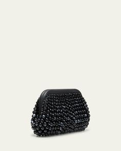 Cult Gaia "Nia" clutch bag in beaded acrylic and leather     Structured top with hinge closure     Lining: Polyester/polyurethane    Approx. 6.5"H x 12.5"W x 3"D    Imported Beaded Top Handle Evening Bag, Black Beaded Pouch Clutch, Leather Top Handle Clutch For Party, Chic Beaded Handheld Clutch, Handheld Leather Clutch For Parties, Rectangular Leather Evening Coin Purse, Evening Clutch With Pearl Handle, Rectangular Leather Coin Purse For Evening, Evening Handheld Beaded Clutch