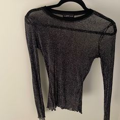 Black Shear Top Never Worn. Doesn’t Have Original Tags. Has Stretch. Lettuce Cut Hem With Glitter. Black Glitter Long Sleeve Top, Edgy Black Mesh Top For Evening, Black Mesh Top For Party Season, Party Top With Sheer Detail And Crew Neck, Black Stretch Top With Glitter, Black Glitter Stretch Top, Edgy Mesh Top For Fall Party, Black Crew Neck Top For Party, Black Glitter Tops For Party Season