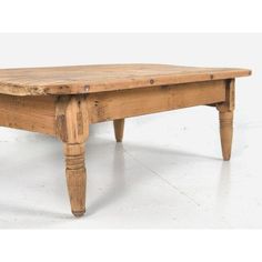 an old wooden coffee table with turned legs