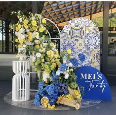 flowers are arranged on display in front of a sign