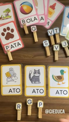 several matching cards with animals and words on them are displayed in front of a wooden table