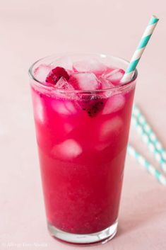 two glasses filled with pink liquid and ice