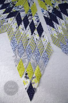 a close up of a piece of fabric with different patterns on it, including blue and yellow