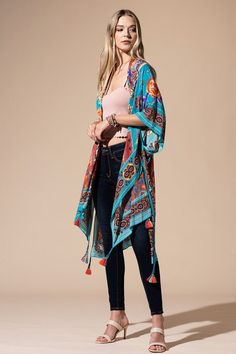 The bohemian wardrobe staple every woman needs! This stunning mixed floral print kimono features breezy side slits, half-length kimono sleeves, and a relaxed oversize fit. Throw it on at the beach for a quick cover-up or style it with your favorite jeans and a band tee for a cool everyday look. Mixed floral print Relaxed, oversize fit 1/2 length kimono sleeve Mid-length Side vents Open front Bohemian style One size fits most 100% Viscose Length: 38" Width: 40" Cover-up Boho Print Cover-up With Kimono Sleeves For Beach Season, Bohemian Printed Kimono For Beach Cover-up, Printed Kimono Beach Cover-up For Beach Season, Bohemian Kimono With Boho Print For Beach Cover-up, Boho Print Tunic Kimono For Beach Cover-up, Blue Tunic Cover-up For Spring, Bohemian One Size Beach Season Cover-up, Bohemian Multicolor Tassel Cover-up, Hippie Kimono For Spring