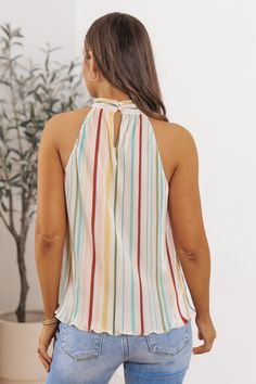 Our Plisse Multi Stripe Pleated Top is crafted with lightweight plisse fabric, featuring vibrant multi-colored stripes that add a pop of color and personality to any outfit! With its relaxed fit and airy feel, it's perfect for warm weather days or layering under a cardigan or jacket when the temperature drops. Pair it with jeans or shorts for a casual and effortless ensemble, or dress it up with tailored trousers or a skirt for a more polished look. Chic Vertical Stripes Blouse For Spring, White Vertical Stripes Top For Vacation, Chic Spring Blouse With Vertical Stripes, White Vertical Stripes Top For Beach, Chic Vertical Stripes Summer Blouse, Striped Tops For Summer Vacation, Casual Vertical Stripes Blouse For Day Out, Striped Summer Beach Top, White Vertical Stripes Blouse For Spring