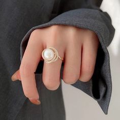 Live your vintage inspired dreams with our pearl and diamond ring. With the pearl bead in the middle and CZ Diamonds surrounding this is the perfect romantic gift for an engagement ring.• Material: High Quality 14K Gold Plated• Finish: 14K Gold Elegant Luxury Pearl Ring, Luxury Rings With Pearl Pendant For Gift, Luxury Stackable Pearl Ring Gift, Luxury Diamond Pearl Engagement Ring, Luxury Platinum Pearl Ring Gift, Luxury Pearl Drop Wedding Ring, Luxury Everyday Yellow Gold Pearl Ring, Luxury Timeless Yellow Gold Pearl Ring, Elegant White Diamond Ring For Proposal