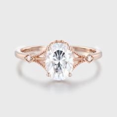 a rose gold engagement ring with an oval cut diamond in the center