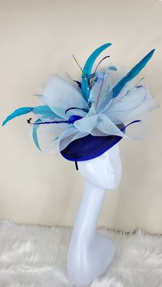 Beautiful multi blue color Fascinator with feathers and flowers. Style to go with a variety of outfits: bridesmaids, cocktail party, Kentucky Derby, Rehearsal dinner, Easter and church outfits. Ones with hair clip and headband. Are you trying to match an outfit? Send a picture and I will help you find a best hat to match your outfit. - Rare find - Ready to ship - Lightweight - Free Shipping - Fast shipping - Customize by adding different color flowers and or feathers Check my store for for style Cheap Adjustable Blue Costume Hats And Headpieces, Luxury Blue Costume Hats And Headpieces For Summer, Luxury Blue Hat Bands For Kentucky Derby, Luxury Blue Headpiece For Kentucky Derby, Luxury Blue Costume Hat For Kentucky Derby, Luxury Blue Headpieces For Kentucky Derby, Luxury Blue Hat For Kentucky Derby, Luxury Blue Costume Hats For Summer, Affordable Fun Blue Hats