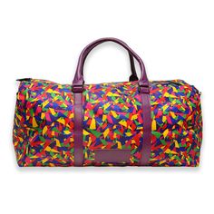 When you're the life of the party, even your duffel bag gets in on the action. The perfect size for a weekend away, this colorful duffel is printed with our own rainbow confetti design. Trimmed in purple faux leather, with purple handles, removable purple shoulder strap, a black zipper, and purple canvas interior lining with extra zipper pocket, this duffel has room for a three-day weekend's worth of outfits, including shoes! 22" long by 10" wide by 13.5" tall (56 cm x 25 cm x 34 cm) Purple vega