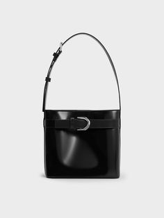 The Gabine collection is expanded with a brand new silhouette -- a sleek and slouchy bucket style. Made with black calf leather, this bag promises excellent style mileage and versatility. It will complement a wide range of styles, from casual to edgy. Fitted with a magnetic closure, it also offers easy access to your belongings. The thick shoulder strap ensures carrying comfort, and can be easily adjusted to your preferred length. Cheap Black Square Bucket Bag, Luxury Black Pebbled Leather Bucket Bag, Black Leather Bucket Bags, Modern Bucket Shoulder Bag For Business, Chic Rectangular Bucket Bag With Silver-tone Hardware, Modern Office Bucket Bag With Palladium Hardware, Modern Formal Bucket Bag, Chic Black Business Bucket Bag, Elegant Business Bucket Bag With Palladium Hardware